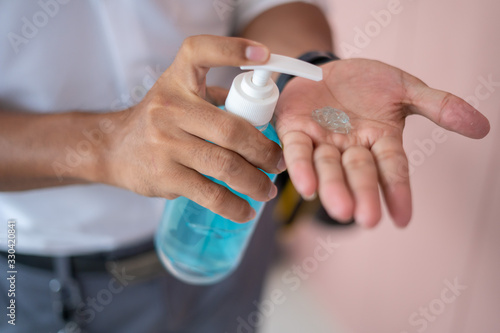 Men s hands use hand sanitizer  hand wash gel  dispenser pump to prevent communicable diseases.