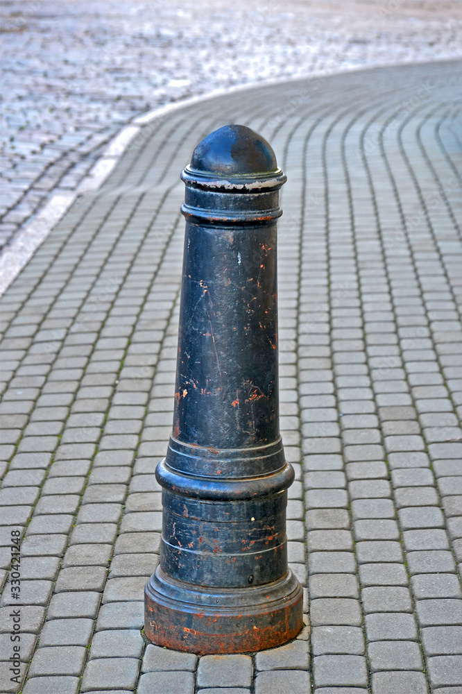 cast iron metal pylon barrier on the street, walking area zone security cast iron metal pylon barrier on the street, walking area zone security