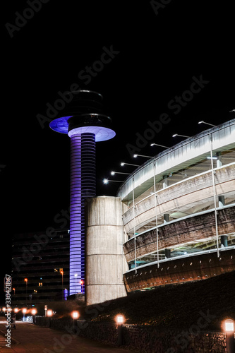 Stockholm, Sweden  The control tower and a parking garage at night. photo