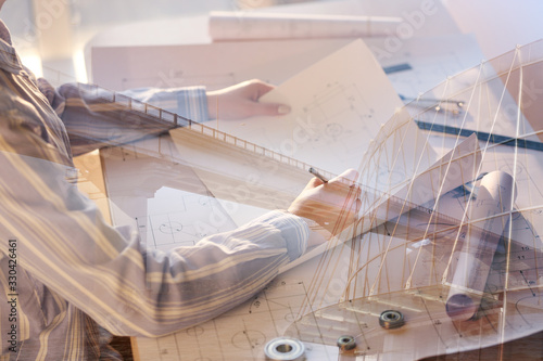 Triple exposure of female architect working in office, modern building and bridge photo