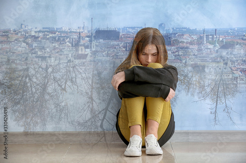 Sad teenage girl near color...