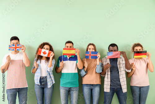 Young students of language school on color background photo