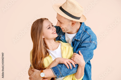 Happy young couple on color...