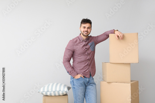Young man with moving boxes...