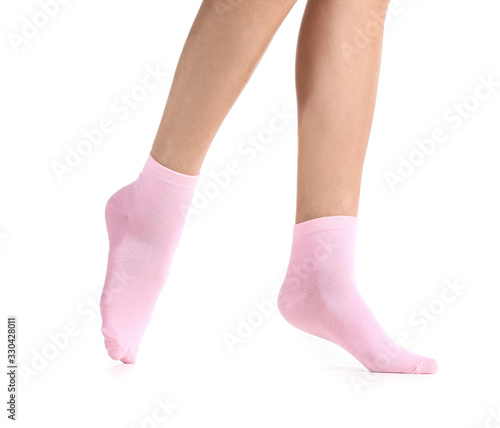 Legs of young woman in socks on white background