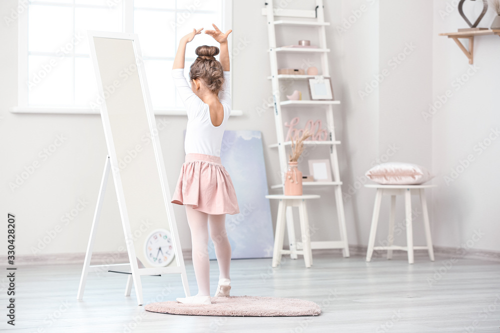 Cute little ballerina looking in mirror at home Cute little ballerina looking in mirror at home