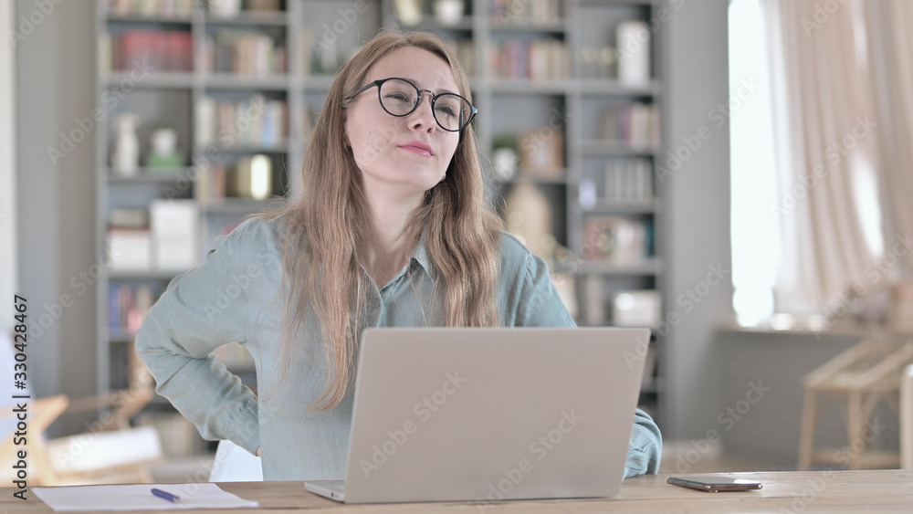 The Portrait of Tired Woman having Back Pain in Office The Portrait of Tired Woman having Back Pain in Office