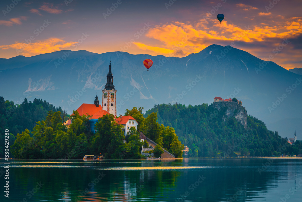 Hot air balloons over the lake Bled at sunrise, Slovenia