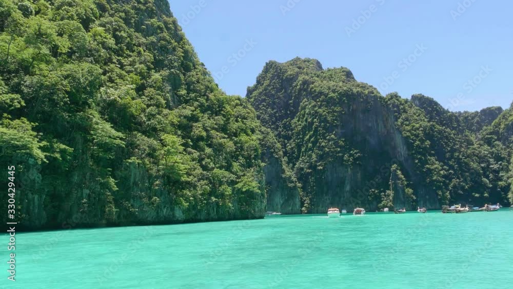 Mountains coming out of the turquoise water Phi Phi Island amazing view in Thailand filming from the boat Beautiful scenery of Asia 4k Mountains coming out of the turquoise water Phi Phi Island amazing view in Thailand filming from the boat Beautiful scenery of Asia 4k