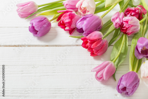 beautiful  tulips on white wooden background