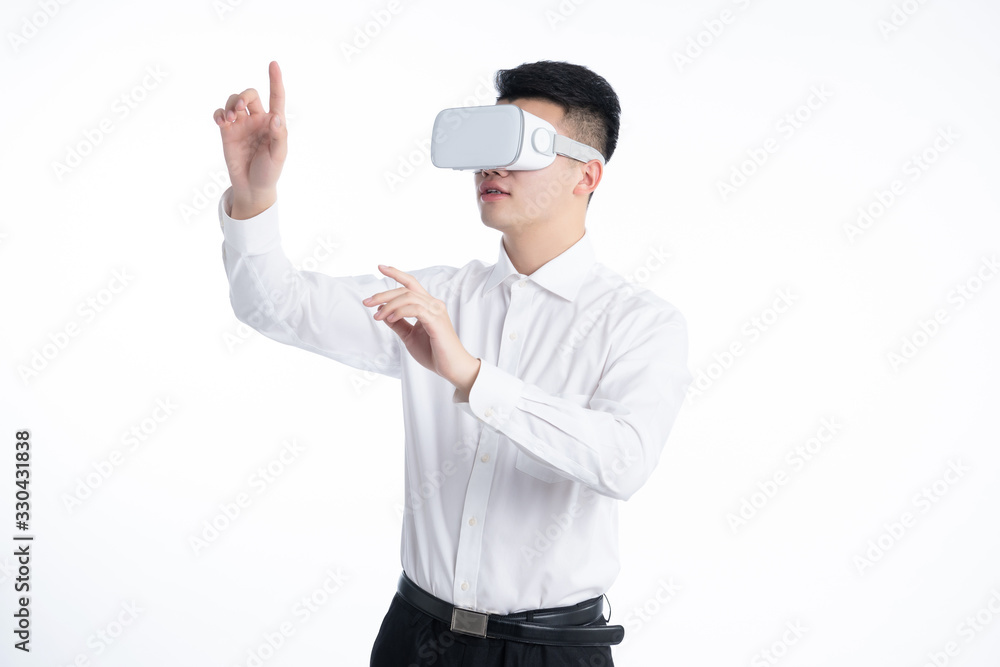 A young Asian man is using his mobile phone and laptop A young Asian man is using his mobile phone and laptop