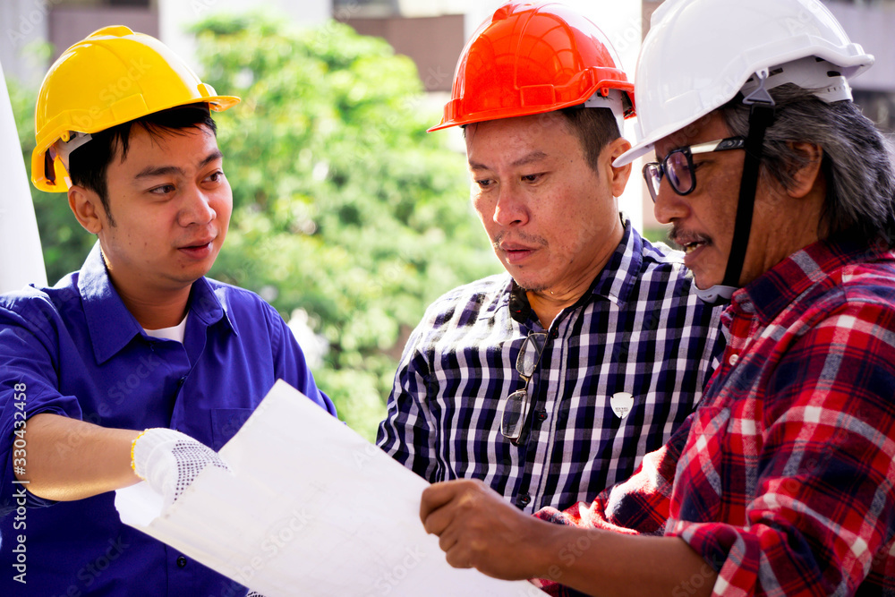 Engineer and worker checking construction plan blueprint and inspect at the site construction buildings concept
Engineer and worker checking construction plan blueprint and inspect at the site construction buildings concept