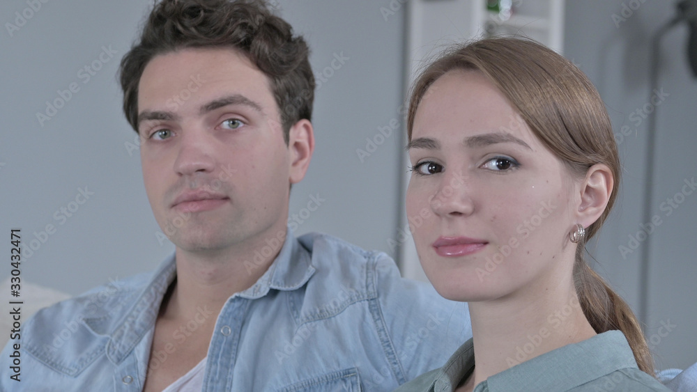 The Portrait of Attractive Couple Turning and Looking at the Camera The Portrait of Attractive Couple Turning and Looking at the Camera