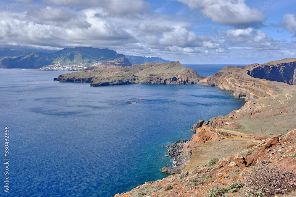 Scenic view of mountain and hills of Point of Saint Lawrence (Ponta de São Lourenço) - the easternmost point of the island of Madeira. Cloudy look of landscape of tropical island in Atlantic ocean Scenic view of mountain and hills of Point of Saint Lawrence (Ponta de São Lourenço) - the easternmost point of the island of Madeira. Cloudy look of landscape of tropical island in Atlantic ocean