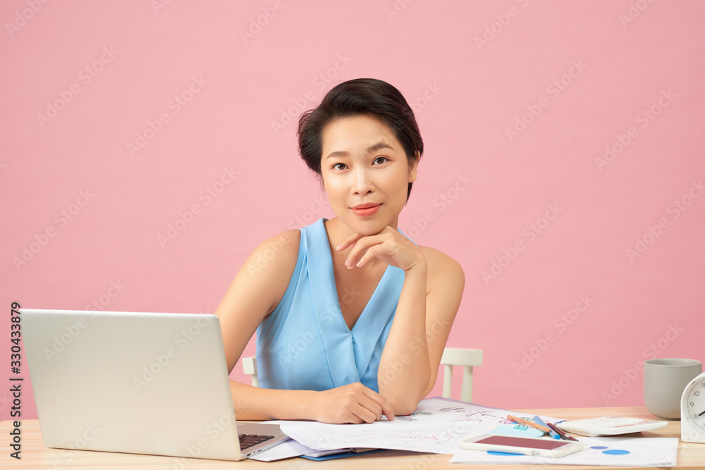 Attractive office worker sitting at desk Attractive office worker sitting at desk