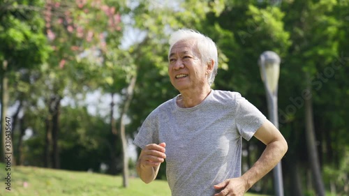 asian old man running jogging outdoors happy and smiling