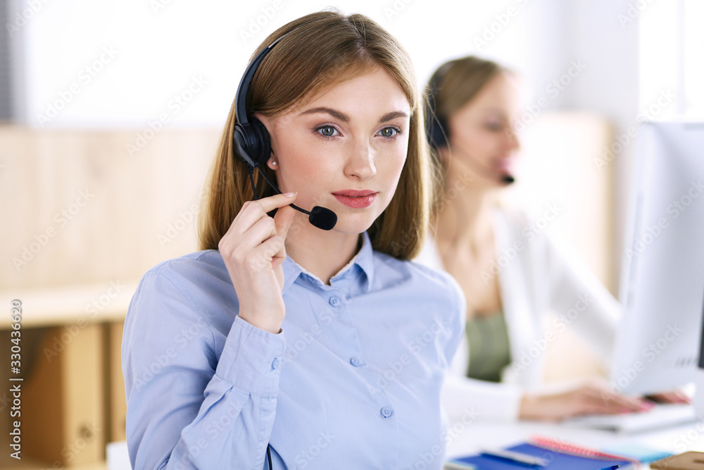 Portrait of call center operator at work. Group of people in a headset ready to help customers. Business concept Portrait of call center operator at work. Group of people in a headset ready to help customers. Business concept