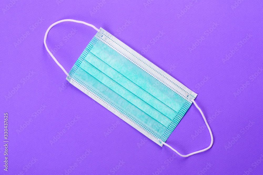 Medical mask on a colored background, a means of protection against coronovirus and epidemic Medical mask on a colored background, a means of protection against coronovirus and epidemic