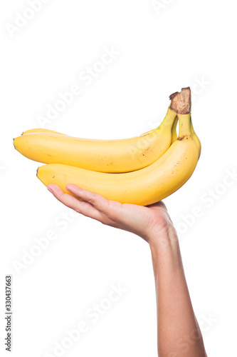 Woman's hand holding a fresh and ripe banana isolated on white background