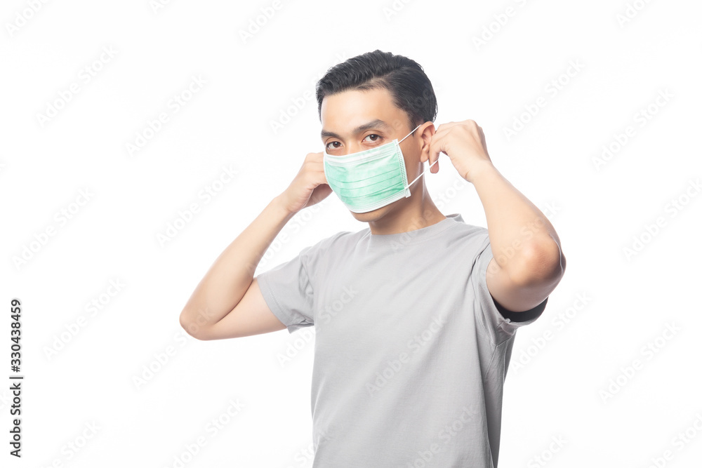 Young Asian Man wearing hygienic mask to prevent infection, 2019-nCoV or coronavirus. Airborne respiratory illness such as pm 2.5 fighting and flu. Studio shot isolated on white background. Young Asian Man wearing hygienic mask to prevent infection, 2019-nCoV or coronavirus. Airborne respiratory illness such as pm 2.5 fighting and flu. Studio shot isolated on white background.