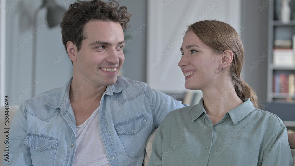 The Portrait of Happy Couple Smiling at Each Other and Looking at the Camera The Portrait of Happy Couple Smiling at Each Other and Looking at the Camera