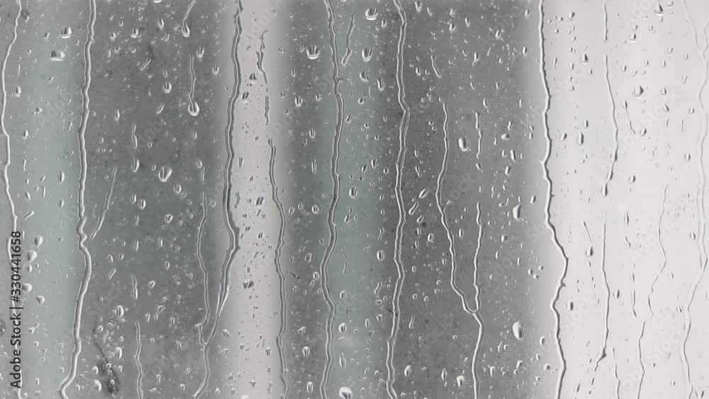 Rain poured down on the window glass. Rain poured down on the window glass.