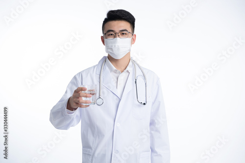 A young Asian doctor is using a device
