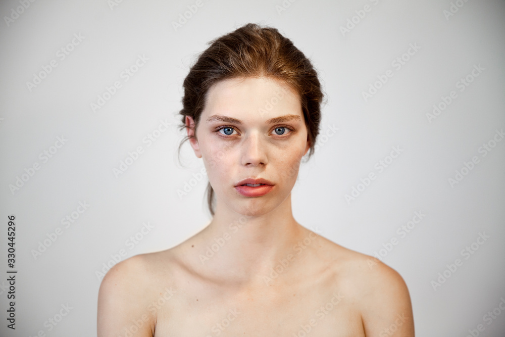 Fototapeta premium portrait of a beautiful natural girl with a clean healthy skin over white background.