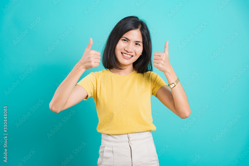 Fototapeta premium Portrait Asian beautiful young woman standing, She made finger thumbs up