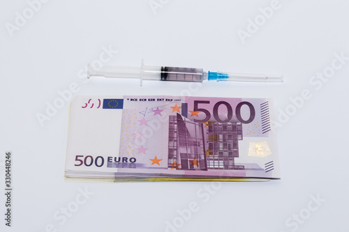 Syringe vaccine and euro bills. Expensive medicine concept.