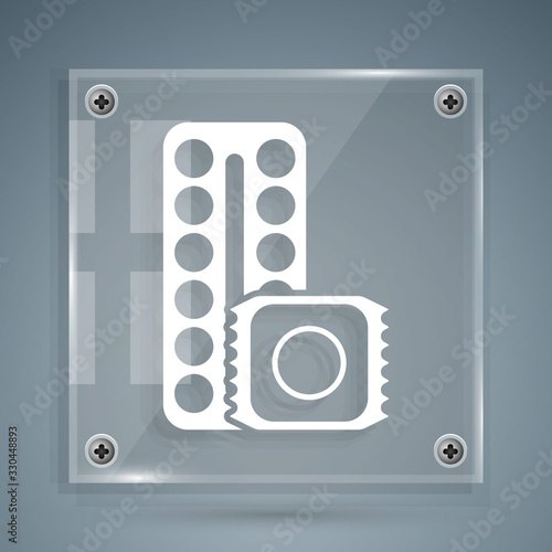 White Packaging of birth control pills and condom in package safe sex icon isolated on grey background. Contraceptive pill. Square glass panels. Vector Illustration