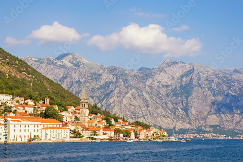 Beautiful Mediterranean landscape on sunny summer day. Montenegro, Adriatic Sea, Bay of Kotor. View of ancient town of Perast , bell tower of church of St. Nicholas