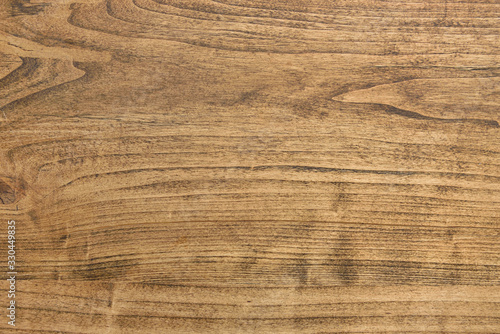 The texture of the wooden surface of a natural board of brown color.