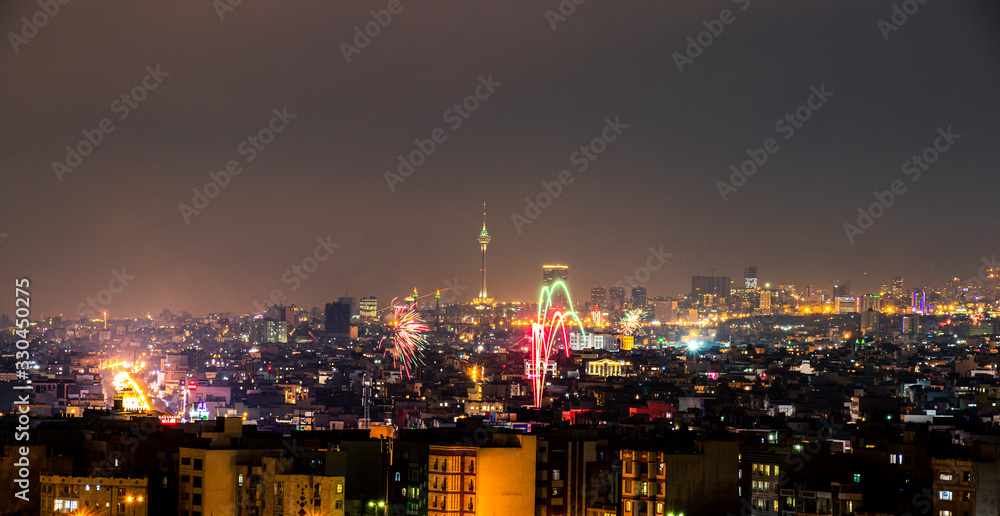 Beautiful and colorful skyline of Tehran city the capital of Iran with amazing fire works in the sky.