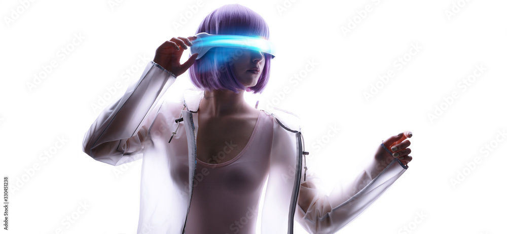 Beautiful woman with purple hair in futuristic costume over white background. Girl in glasses of virtual reality. Augmented reality, game, future technology, AI concept. VR. Blue neon light. Beautiful woman with purple hair in futuristic costume over white background. Girl in glasses of virtual reality. Augmented reality, game, future technology, AI concept. VR. Blue neon light.