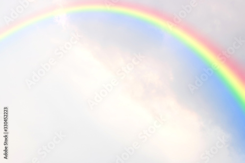 A rainbow in many clouds with sunlight on the sky with copy space. © Kritsada