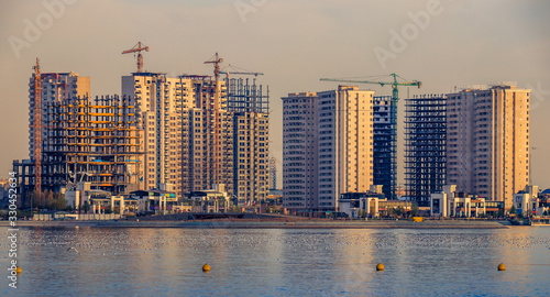 Colorful Tehran skyline with beautiful Chitgar lake at foreground with amazing reflections from sky at the sunset. photo