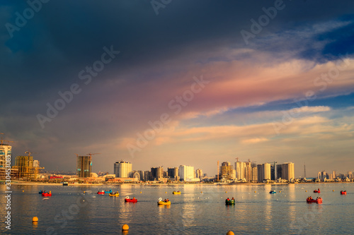 Beautiful long exposure shot of Tehran skyline with Chitgar lake at the foreground and super colorful and smooth sky and water reflections. photo