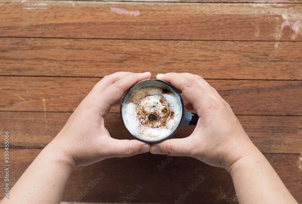 Hot chocolate with marshmallow grill in hand on background Hot chocolate with marshmallow grill in hand on background