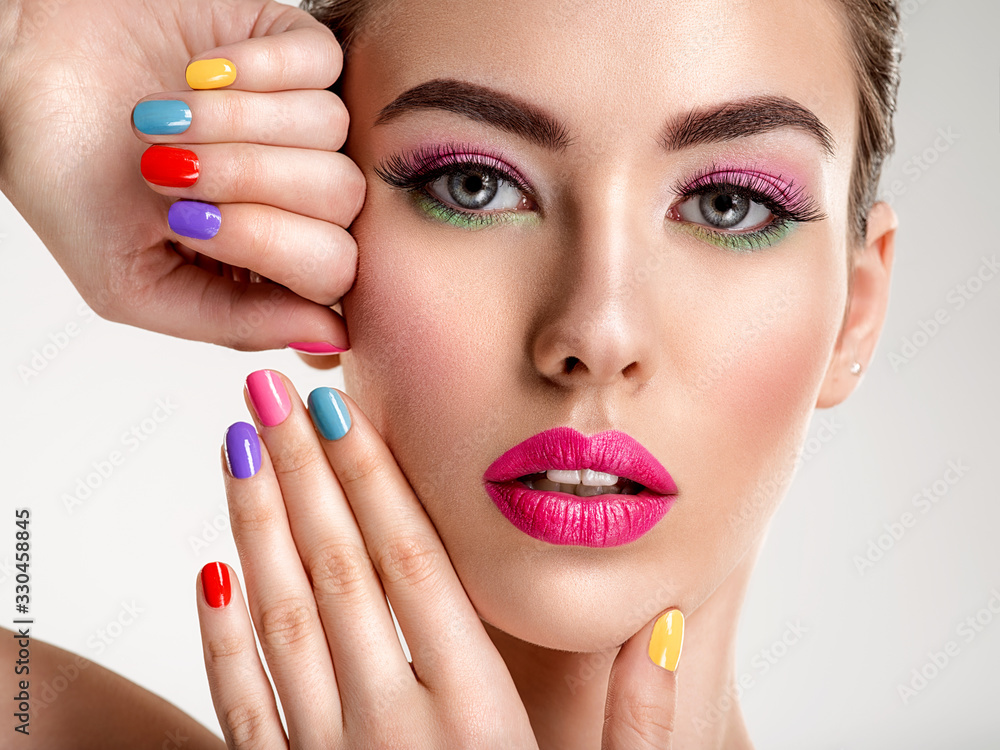 Beautiful fashion woman with a colored nails. Attractive white girl with multicolor manicure. Beautiful fashion woman with a colored nails. Attractive white girl with multicolor manicure.