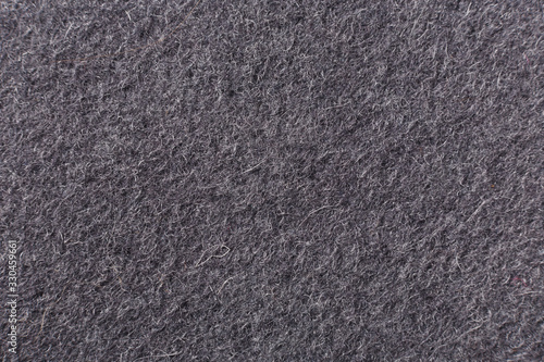 Gray background of felted wool, close up.