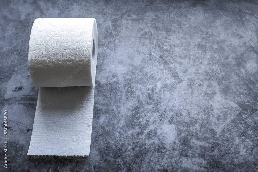 Roll of white soft toilet paper on dark background. Personal hygiene concept. Flat lay, top view. Copy space. Roll of white soft toilet paper on dark background. Personal hygiene concept. Flat lay, top view. Copy space.