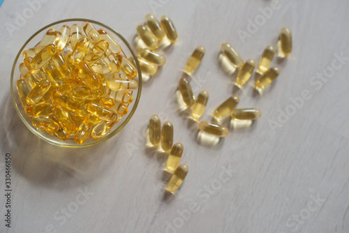 Fish oil pills. Omega-3 gel capsules. Food supplement obtained from cod liver. Healthcare and medical concept. Soft selective focus.