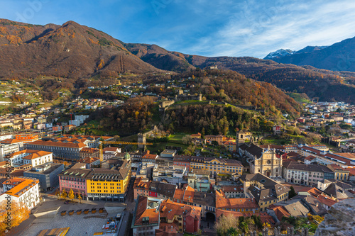 Stunning aerial panorama view of Bellinzona old town with Montebello castle Sasso Corbaro Castle and Swiss Alps with blue sky cloud in background, on sunny autumn day, Ticino, Switzerland