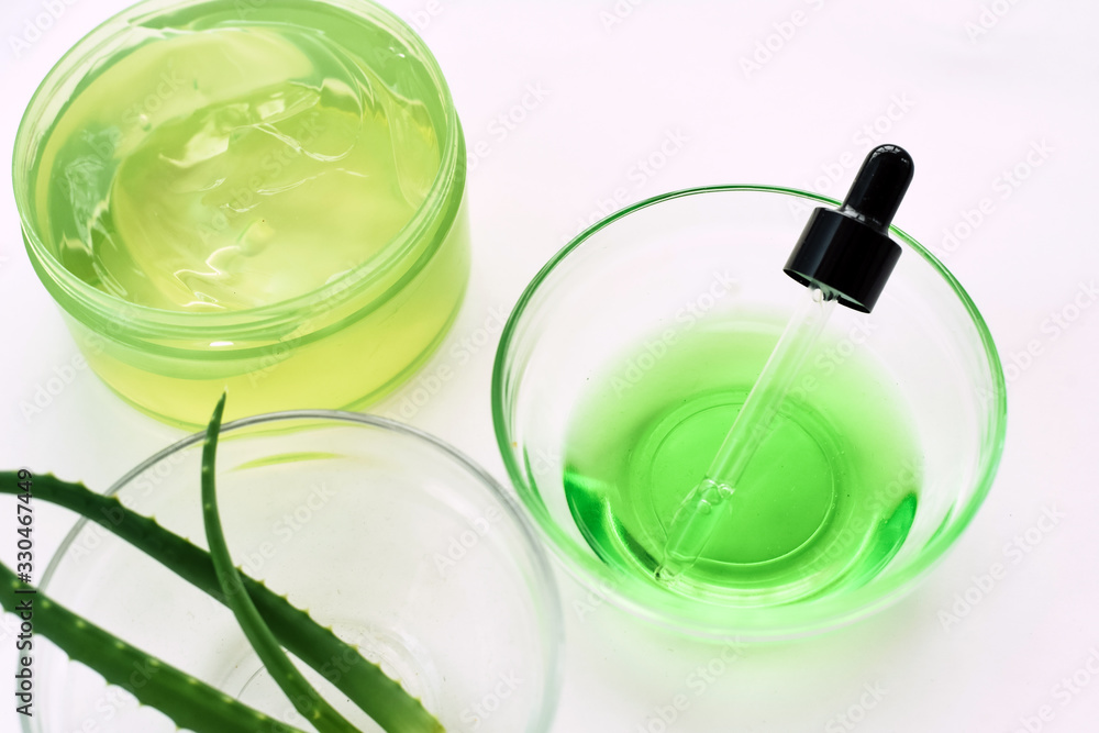 Aloe gel, aloe vera leaves and green serum from natural ingredients on a white background. Making cosmetics at home Aloe gel, aloe vera leaves and green serum from natural ingredients on a white background. Making cosmetics at home