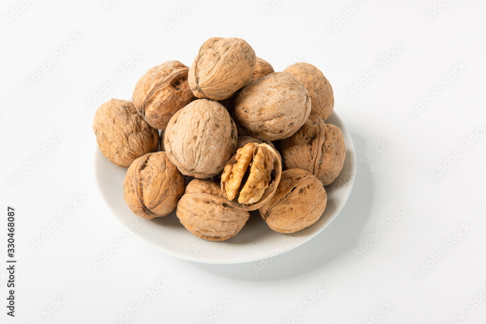 Walnut with shell is isolated on white background after drying Walnut with shell is isolated on white background after drying