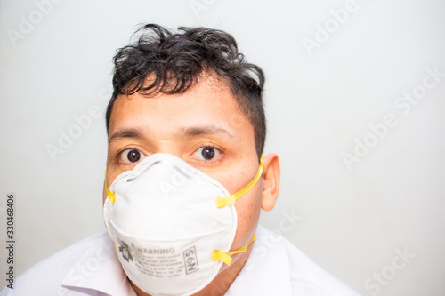 Asian man wearing N95 mank protect from Covid19 and Pm2.5 on white background photo