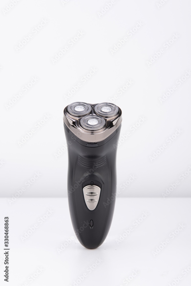 The black electric razor is isolated in the white background The black electric razor is isolated in the white background