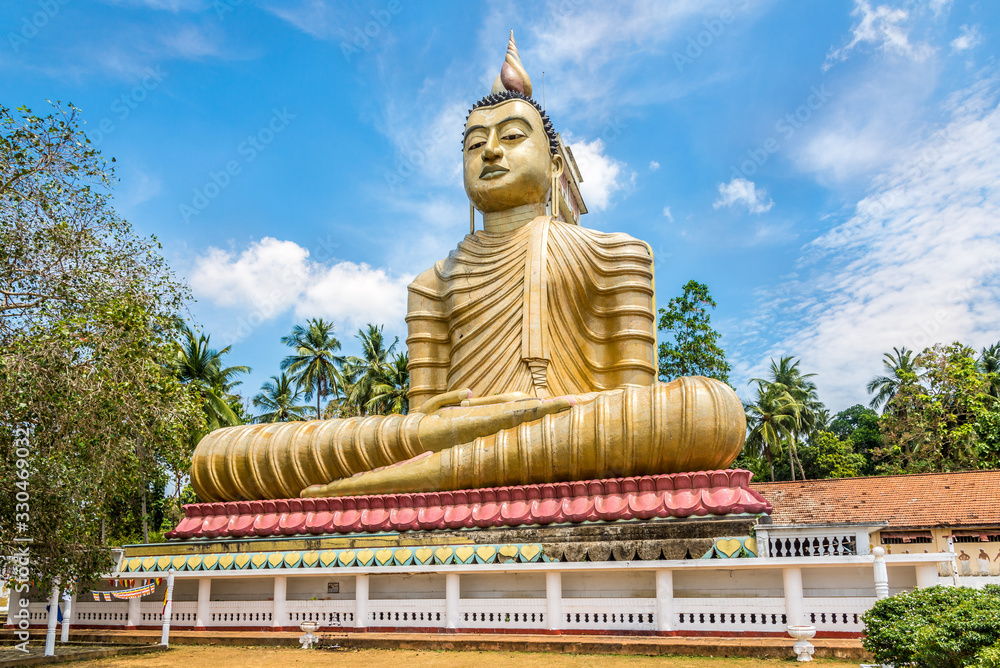 View at the Buddha statue near temple Wewurukannala Vihara in Dikwella - Sri Lanka View at the Buddha statue near temple Wewurukannala Vihara in Dikwella - Sri Lanka