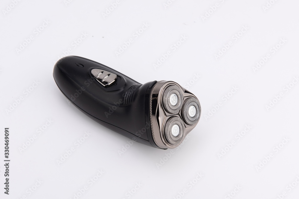 The black electric razor is isolated in the white background The black electric razor is isolated in the white background